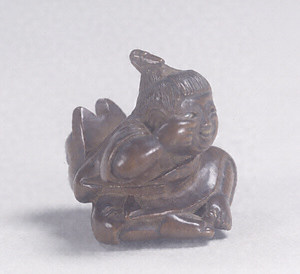 Toggle ("Netsuke") in the Shape of a Boy with a Fox Mask