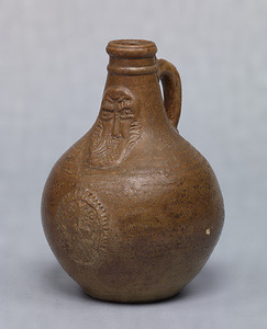 Vase Brown glaze with human face design in relief