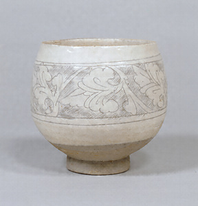 Bowl Transparent glaze on white slip with carved arabesque design