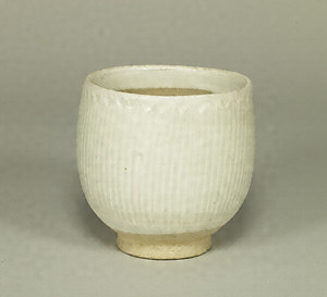 Bowl Transparent glaze on white slip with carved lotus petal design